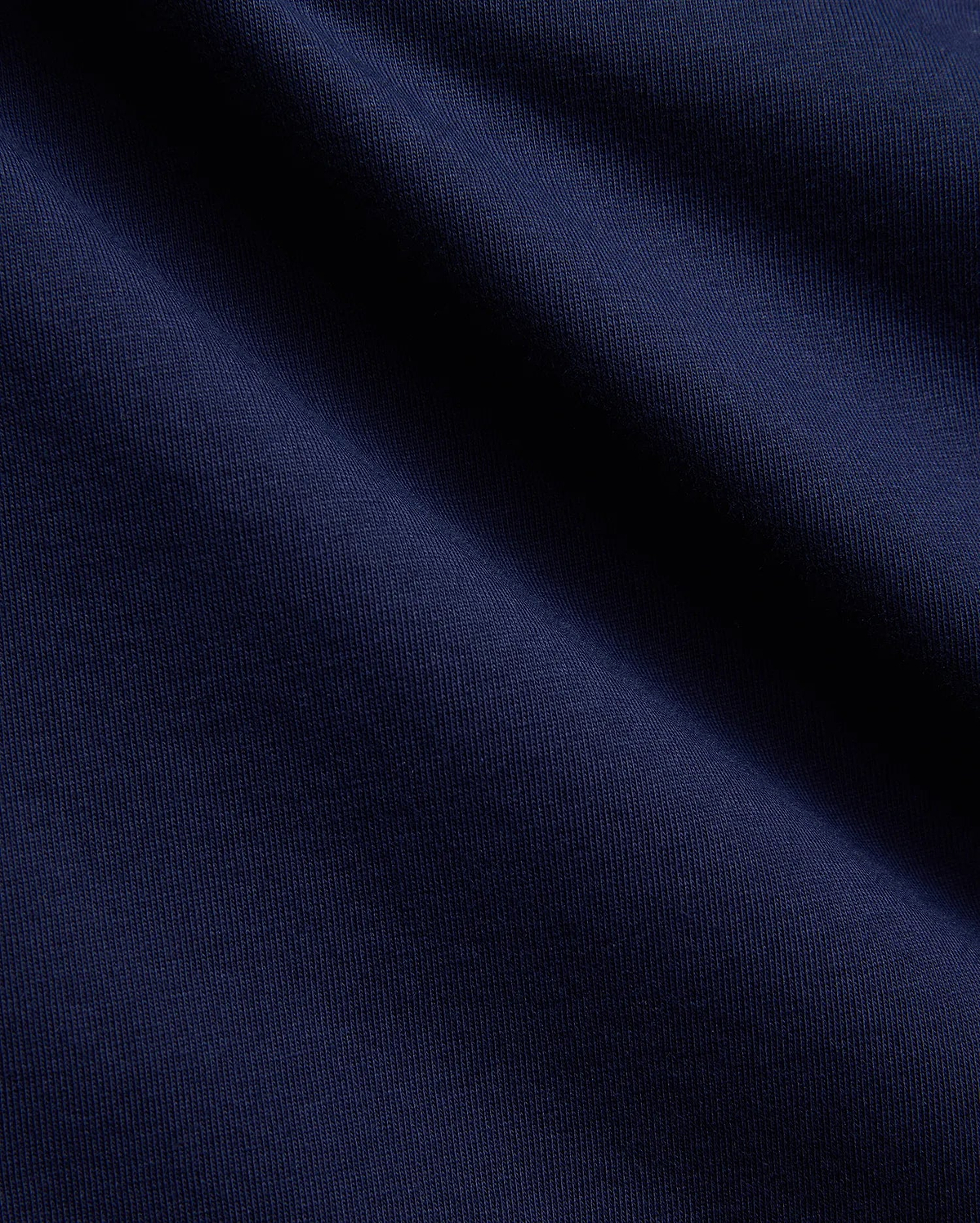 Mens Ethan Graphic Tee in a deep, luxurious navy blue, crafted from a premium, soft-touch jersey knit fabric with a subtle vertical ribbed texture, perfect for sophisticated streetwear. (2)