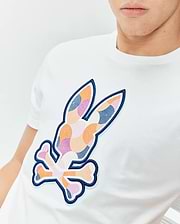 Mens Ethan Graphic Tee: White classic fit jersey t-shirt featuring a prominent, central, multi-colored mosaic Psycho Bunny skull logo with a dark blue embroidered outline. (3)