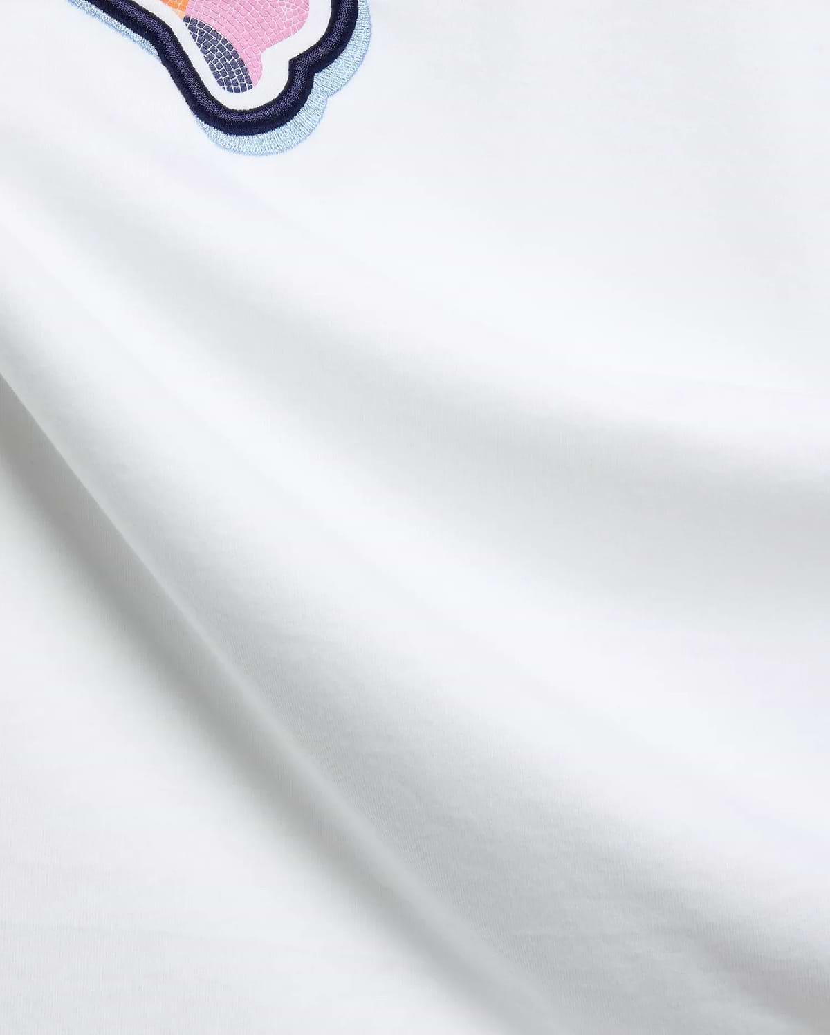 White Mens Ethan Graphic Tee, classic fit jersey, featuring a large embroidered Psycho Bunny skull logo with dark blue, light blue, pink, and orange mosaic details. (6)