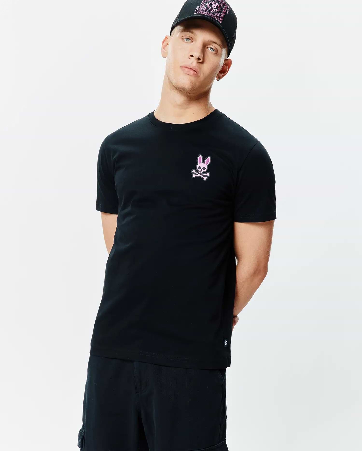 Mens Frank Back Graphic Tee, a black classic fit jersey t-shirt with a small embroidered pink Psycho Bunny skull logo on the left chest and a back graphic.