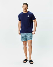 Navy blue classic fit jersey Mens Frank Back Graphic Tee with a small white embroidered Psycho Bunny skull logo on the chest, paired with teal geometric patterned shorts featuring repeated bunny skull motifs.