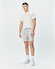 Mens Frank Back Graphic Tee, cream jersey with small blue/orange Psycho Bunny chest logo, and relaxed shorts featuring an orange/blue tiled pattern with bunny skull logos and a blue drawstring.