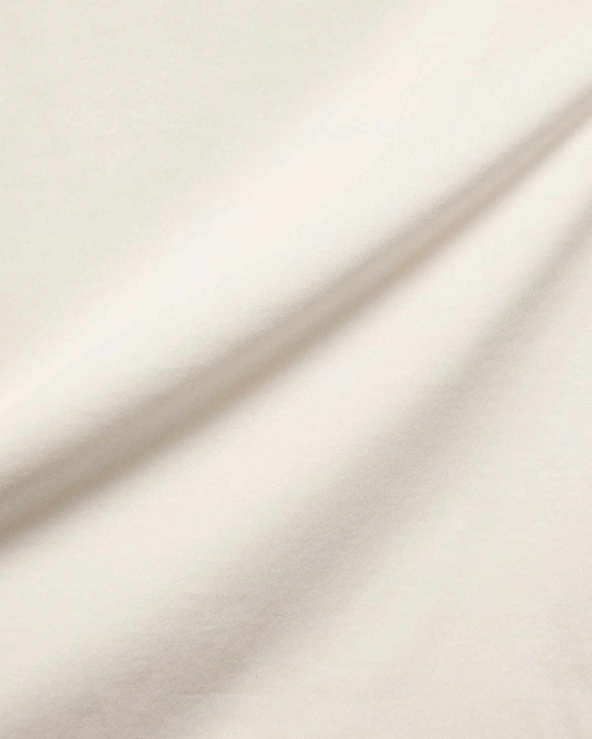 Mens Frank Back Graphic Tee, a premium ecru jersey knit fabric, soft and smooth with subtle folds, embodying refined streetwear style and comfort, perfect for a distinctive graphic.