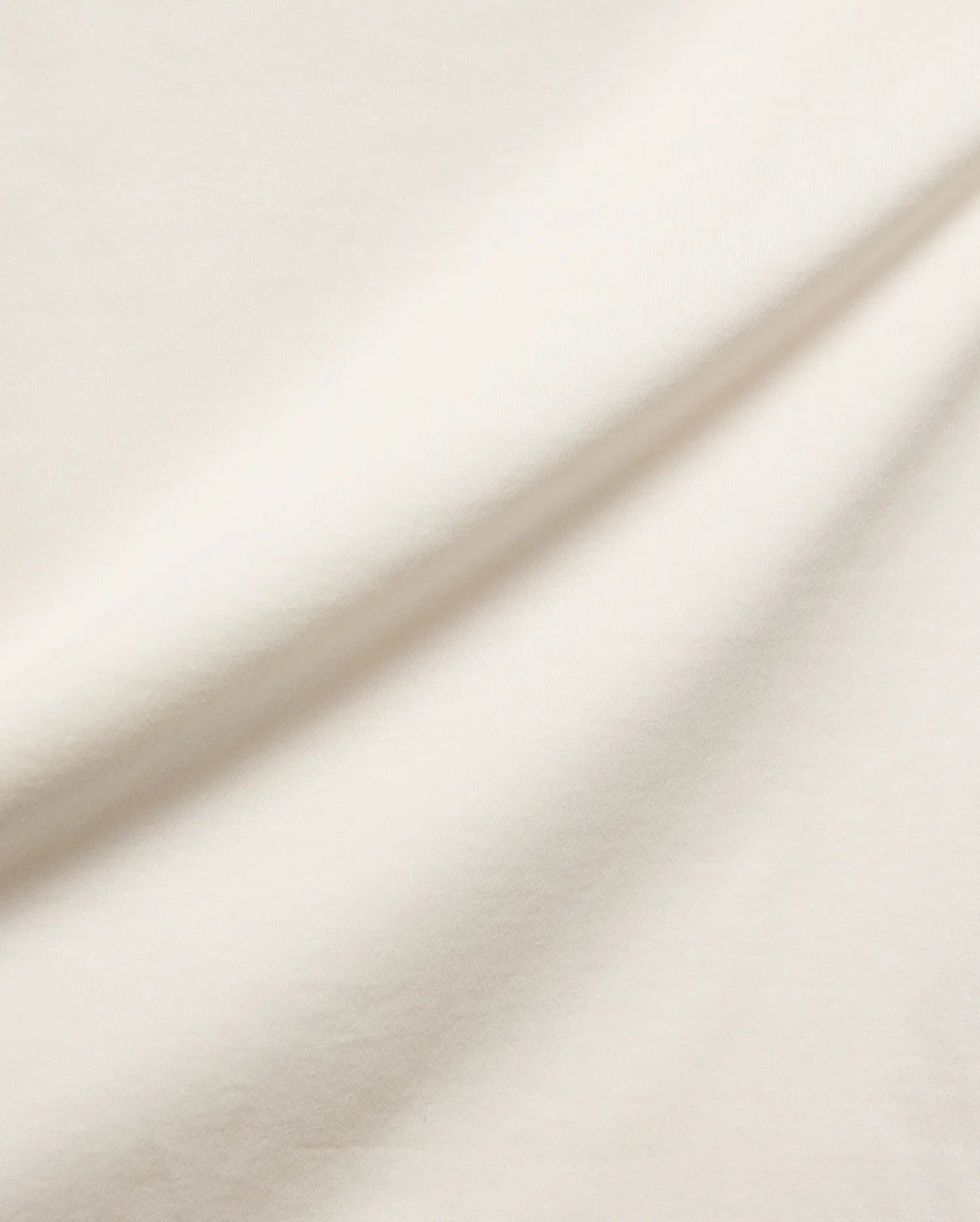 Mens Frank Back Graphic Tee, a premium ecru jersey knit fabric, soft and smooth with subtle folds, embodying refined streetwear style and comfort, perfect for a distinctive graphic.
