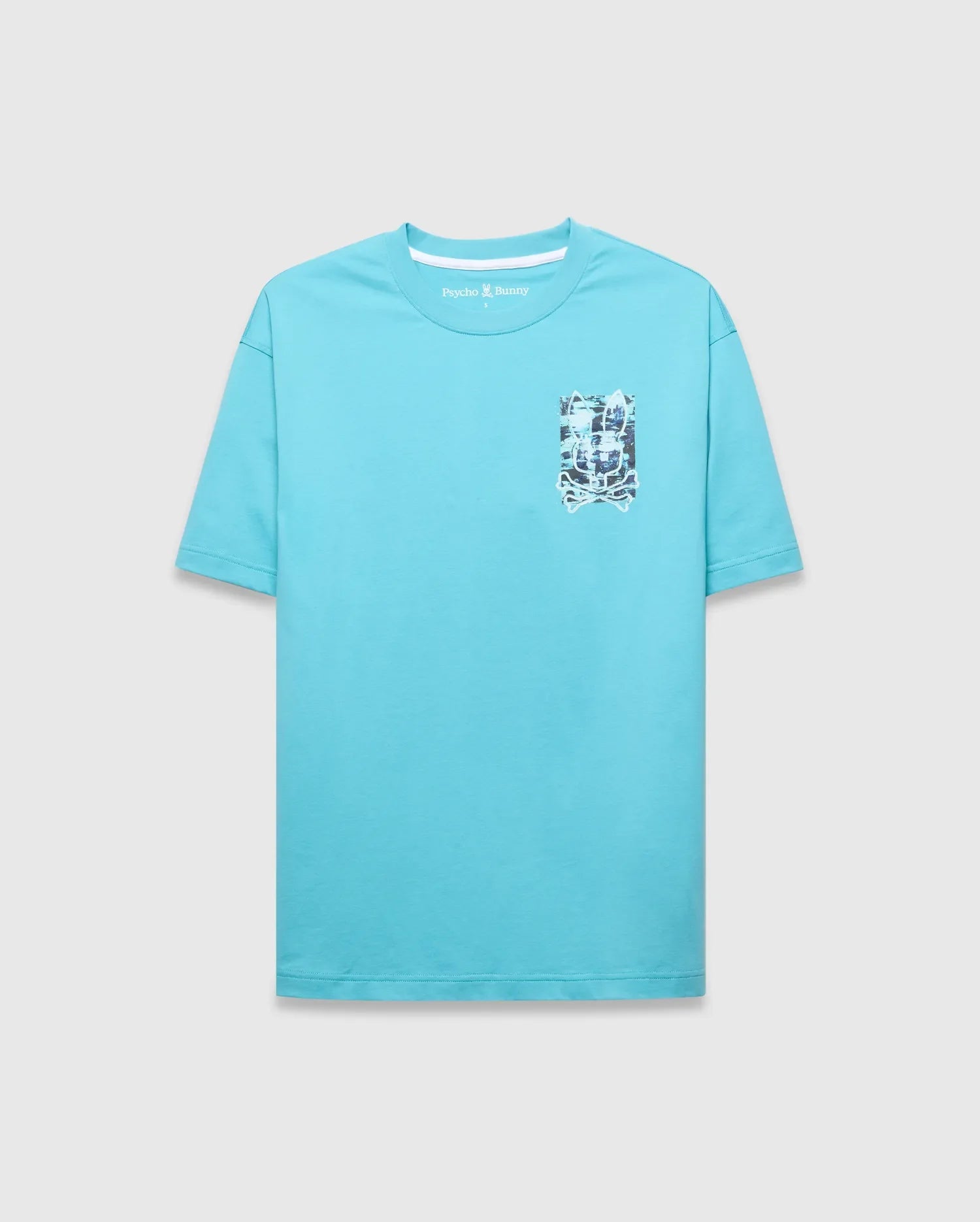 Mens Isaac Relaxed Fit Tee, an aqua jersey t-shirt with a relaxed fit, featuring a small embroidered Psycho Bunny logo and a larger multi-color graphic skull print on the left chest.