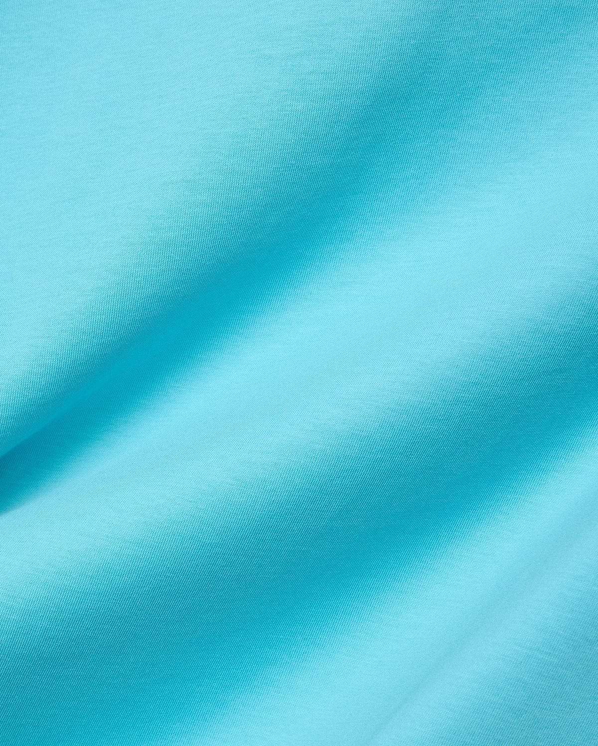 Mens Isaac Relaxed Fit Tee in bright aqua blue, soft jersey knit fabric with visible subtle texture and gentle folds, featuring the iconic small embroidered Psycho Bunny skull logo on the chest.