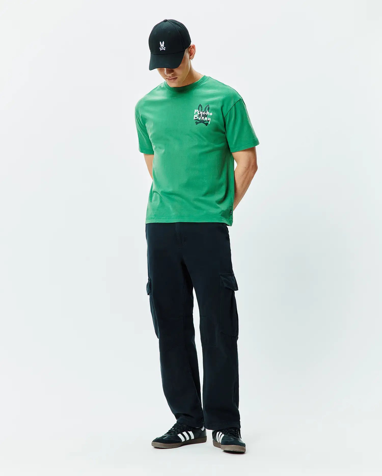 Mens Duncan Relaxed Fit Tee. Vibrant green jersey t-shirt with a relaxed fit, featuring a white embroidered Psycho Bunny skull logo and text on the left chest.