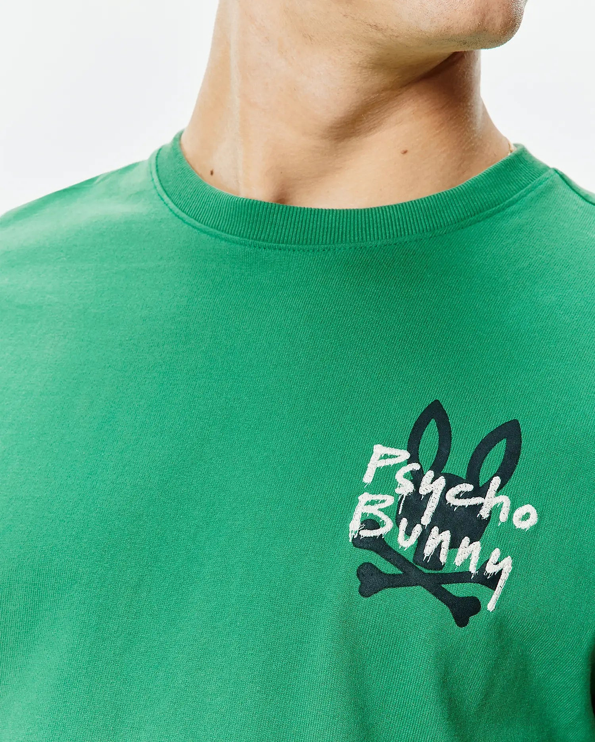 Mens Duncan Relaxed Fit Tee in vibrant green jersey knit, featuring a medium-sized distressed black and white Psycho Bunny skull logo print on the left chest.