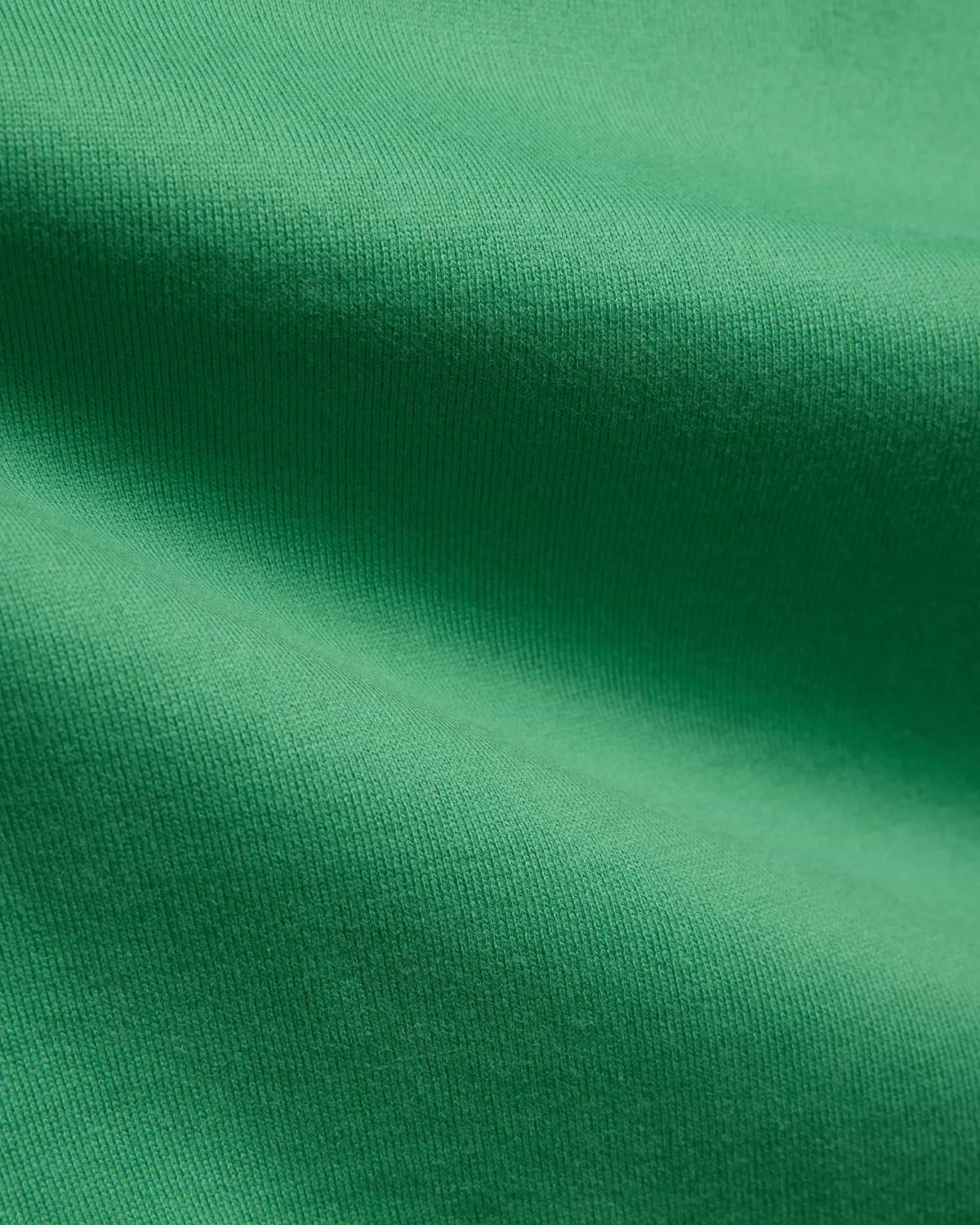 Mens Duncan Relaxed Fit Tee in vibrant emerald green, featuring a soft, premium jersey knit fabric with subtle vertical ribbing, emphasizing its comfortable, relaxed fit.