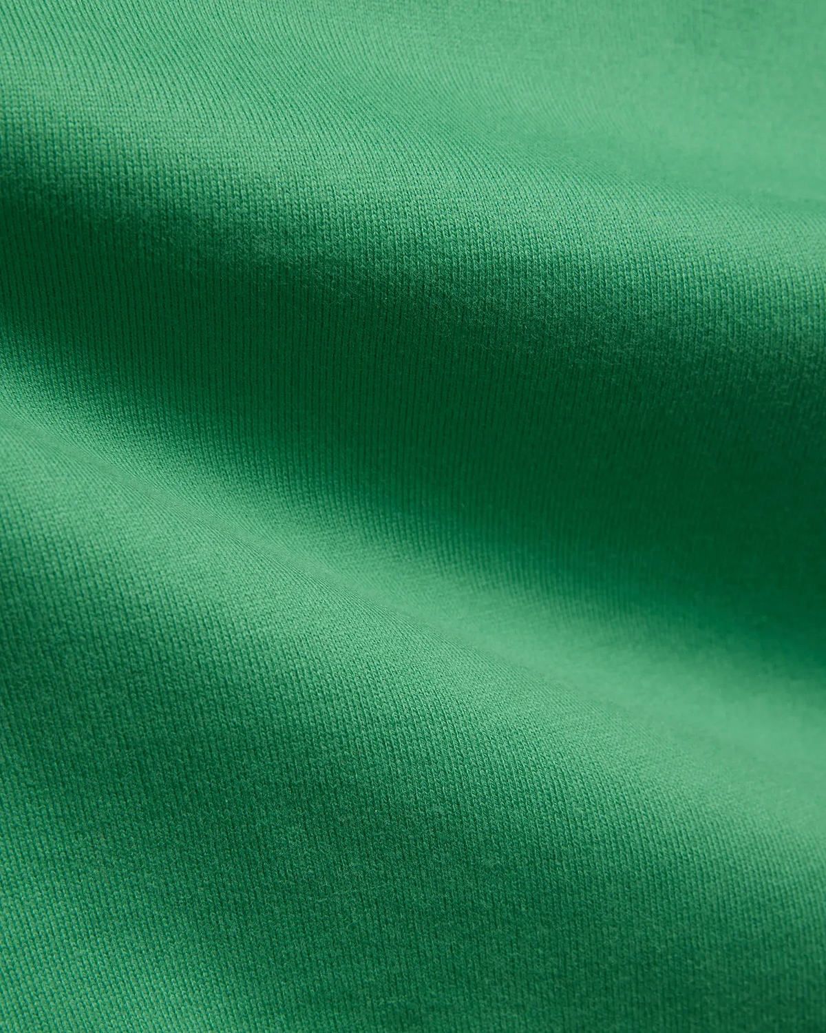 Mens Duncan Relaxed Fit Tee in vibrant emerald green, featuring a soft, premium jersey knit fabric with subtle vertical ribbing, emphasizing its comfortable, relaxed fit.