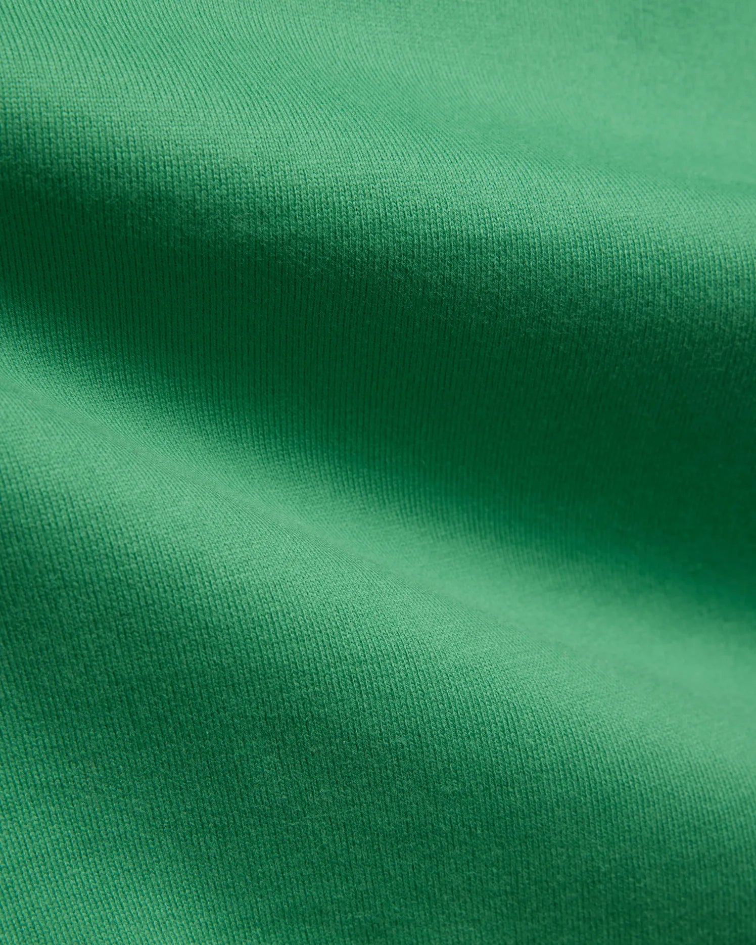 Mens Duncan Relaxed Fit Tee in vibrant emerald green, featuring a soft, premium jersey knit fabric with subtle vertical ribbing, emphasizing its comfortable, relaxed fit.