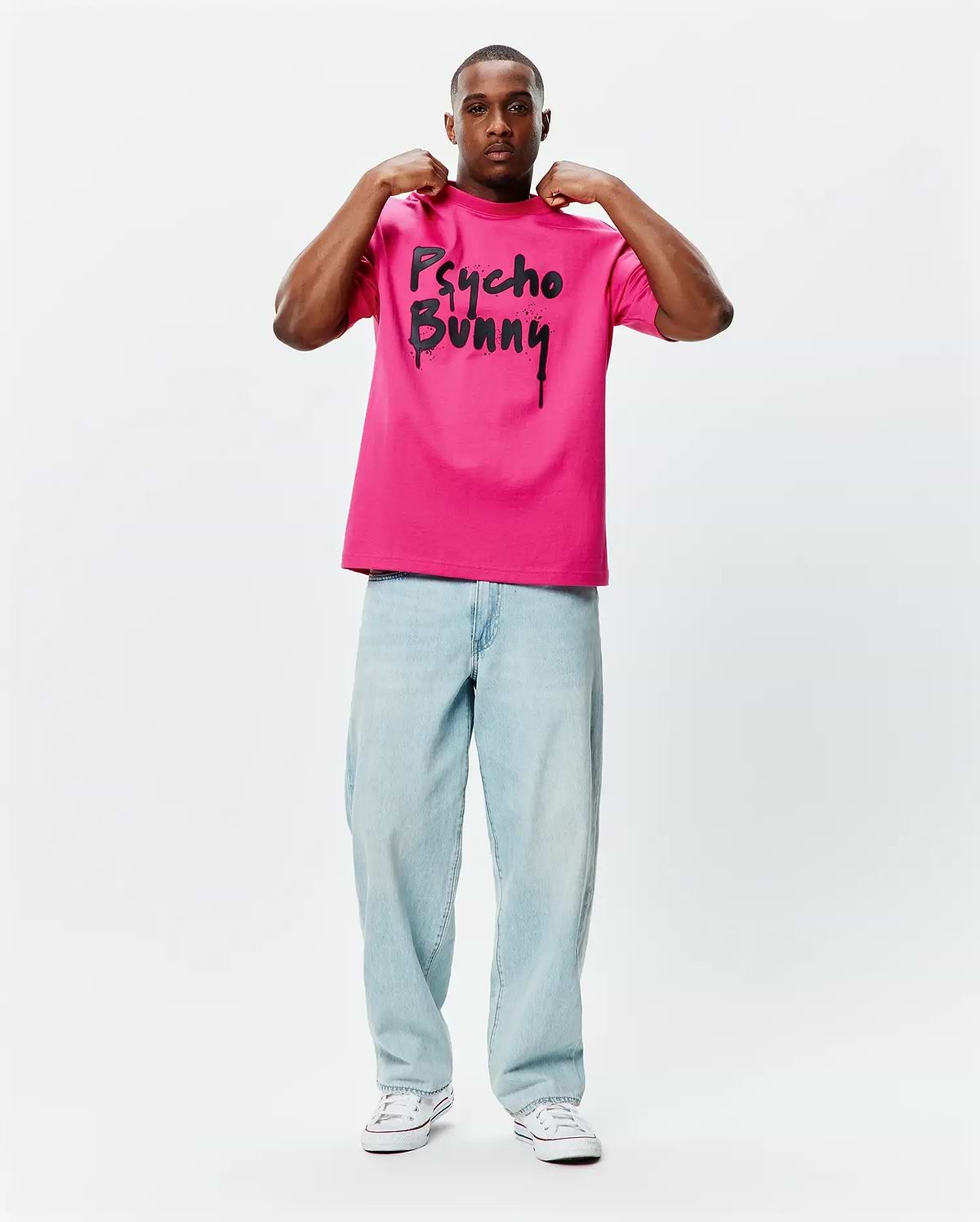 Mens Duncan Wordmark Relaxed Fit Tee in hot pink smooth jersey, featuring a large black Psycho Bunny wordmark graphic with a dripping paint effect on the chest.
