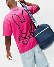 Mens Duncan Wordmark Relaxed Fit Tee in vibrant fuchsia jersey, featuring a large, distressed black Psycho Bunny skull and crossbones graphic prominently on the back.