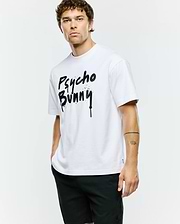 Mens Duncan Wordmark Relaxed Fit Tee, a crisp white cotton jersey t-shirt with a bold, large black spray paint drip effect Psycho Bunny wordmark graphic centered on the chest.