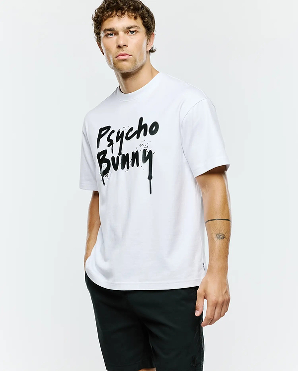 Mens Duncan Wordmark Relaxed Fit Tee, a crisp white cotton jersey t-shirt with a bold, large black spray paint drip effect Psycho Bunny wordmark graphic centered on the chest.