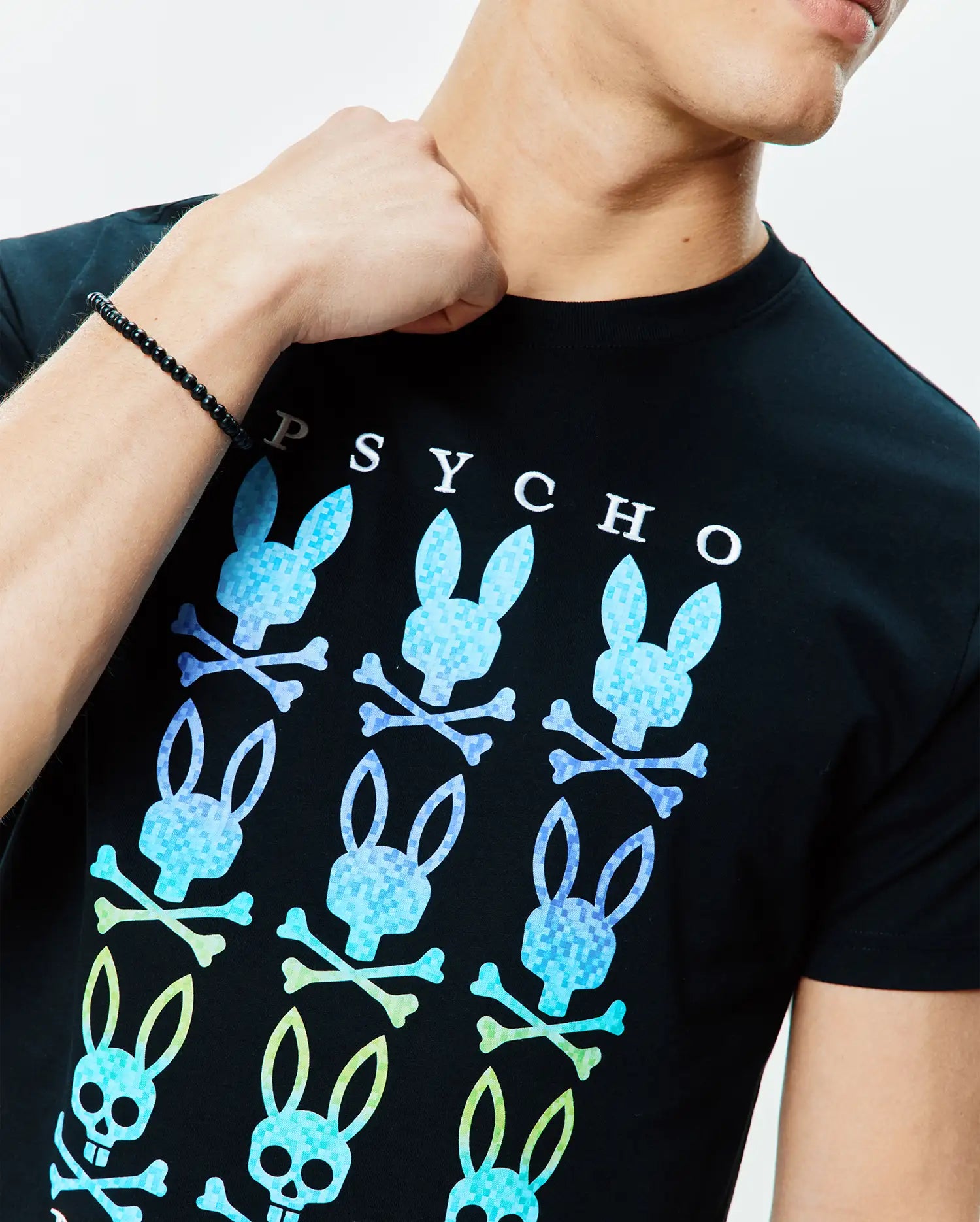Mens Colt Graphic Tee, black classic fit jersey t-shirt with a large chest graphic of gradient blue and green pixelated Psycho Bunny skull and crossbones, and white PSYCHO text. (3)