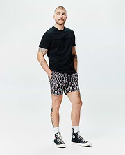 Black Mens Royce Graphic Tee, classic fit, soft jersey, featuring a tonal Psycho Bunny chest graphic, paired with black relaxed-fit shorts showcasing an all-over vibrant bunny skull and crossbones print. (4)
