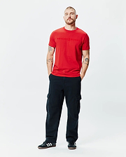 Mens Royce Graphic Tee, a vibrant red classic fit jersey t-shirt featuring a prominent, tonal embossed Psycho Bunny logo text centered on the chest.