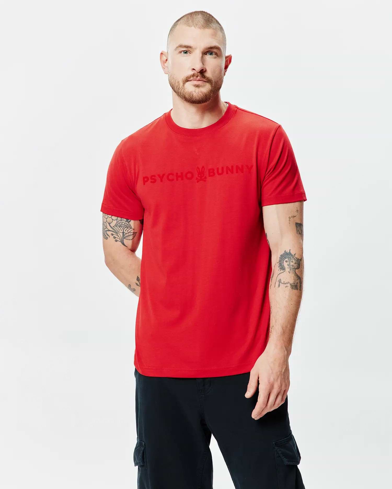 Mens Royce Graphic Tee in vibrant red jersey, featuring a classic fit and a large tonal Psycho Bunny skull logo graphic print centered on the chest.