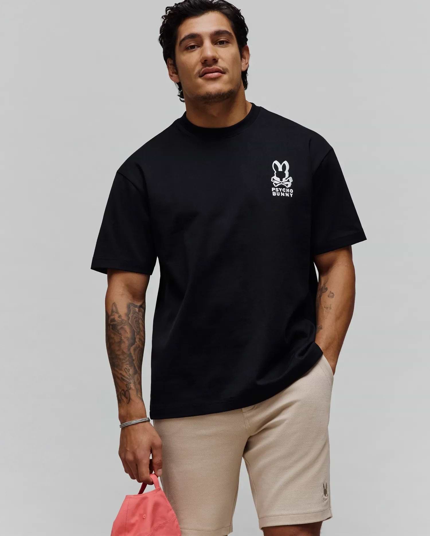 Black Mens Toby Oversized Tee, a relaxed fit in soft jersey knit, showcasing a bold white Psycho Bunny skull logo with PSYCHO BUNNY text on the left chest. (1)