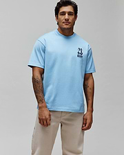 Mens Toby Oversized Tee in light blue, crafted from soft jersey fabric, featuring an iconic small, embroidered navy Psycho Bunny skull and crossbones logo with text on the left chest, embodying refined streetwear. (3)