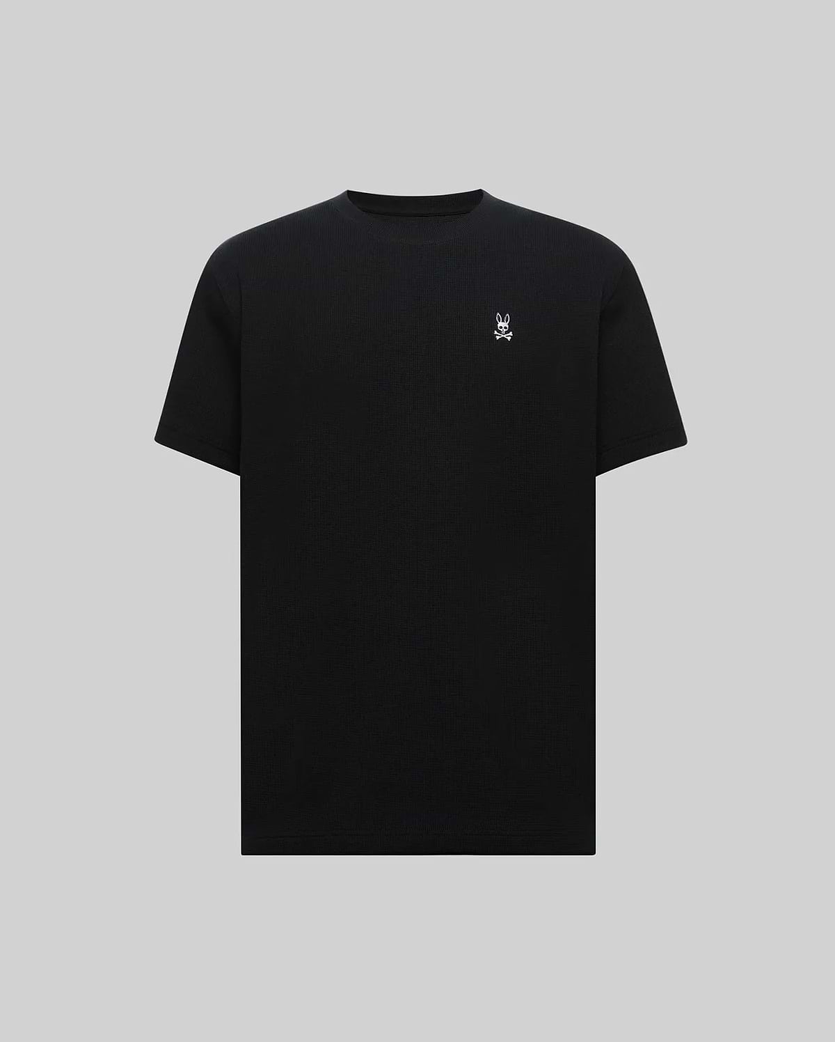 Mens Maxton Waffle Tee in black, featuring a classic fit and textured waffle knit fabric, with a small, embroidered white Psycho Bunny skull logo on the left chest.