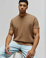 Psycho Bunny Mens Maxton Waffle Tee, a classic fit tan waffle knit t-shirt featuring a small embroidered white and black bunny skull logo on the left chest.