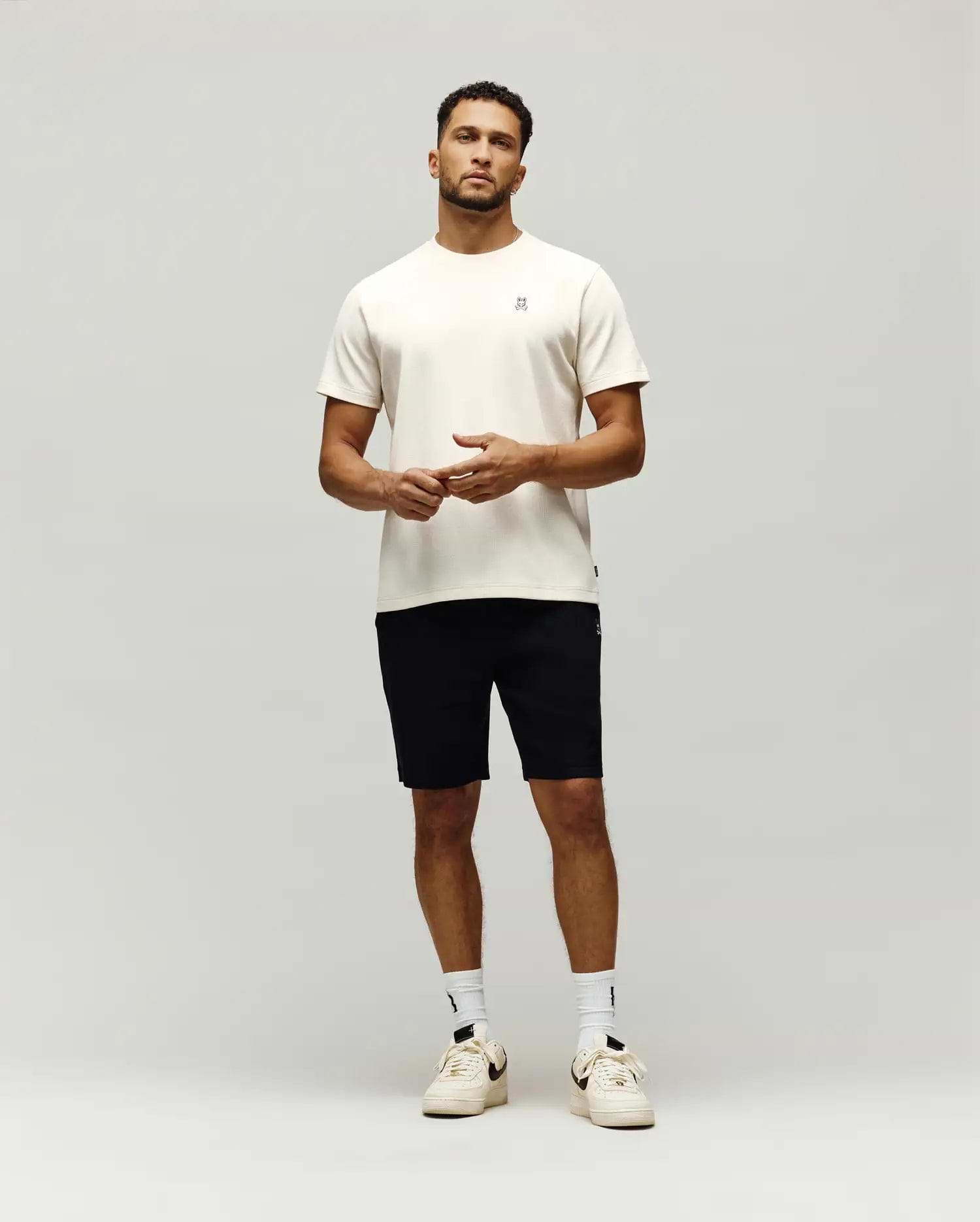 Cream Mens Maxton Waffle Tee with a classic fit, featuring a subtle waffle knit texture and a small, embroidered black Psycho Bunny skull logo on the left chest.