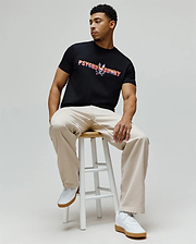 Mens Raphael Wordmark Tee, a classic fit black jersey t-shirt featuring a large, vibrant multi-color striped Psycho Bunny wordmark and skull logo on the chest. (3)