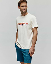 Mens Raphael Wordmark Tee, a cream classic fit jersey t-shirt with a large, vibrant multi-color gradient Psycho Bunny wordmark and skull logo chest graphic. Paired with teal textured knit shorts featuring a small embroidered bunny logo. (3)