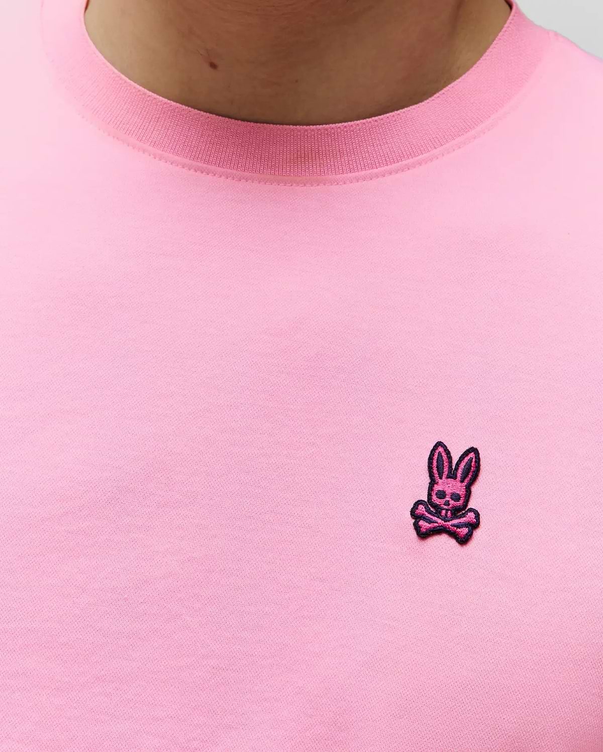 Mens Clark Performance Tee in vibrant pink, with a ribbed crew neck and a small, embroidered magenta and black Psycho Bunny skull logo on the left chest, crafted from a smooth jersey knit. (2)