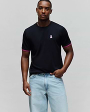 Mens Clark Performance Tee, black jersey knit with a classic fit, featuring a small embroidered pink and white Psycho Bunny skull logo on the left chest and striped pink and white cuffs.