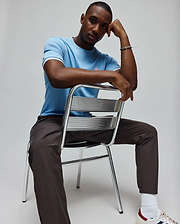 Mens Clark Performance Tee, a light blue classic fit jersey knit t-shirt with a small pink embroidered Psycho Bunny skull logo on the left chest and white, red, navy striped sleeve cuffs. (3)