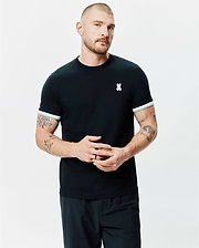 Mens Holden Tee, a classic fit black jersey knit t-shirt with a ribbed crew neck, white striped sleeve cuffs, and a small embroidered white Psycho Bunny skull logo on the left chest.