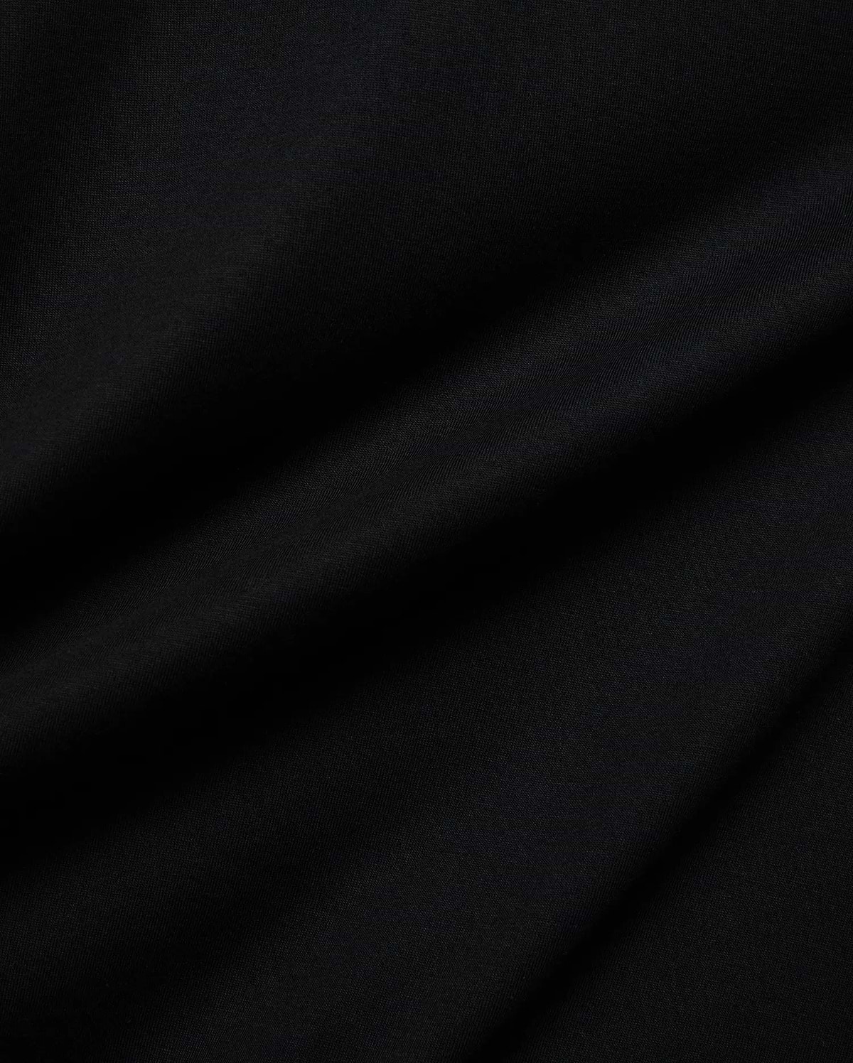 Mens Holden Tee, a premium Psycho Bunny black t-shirt crafted from soft jersey knit fabric, displaying subtle drapes and a smooth texture, reflecting refined quality.