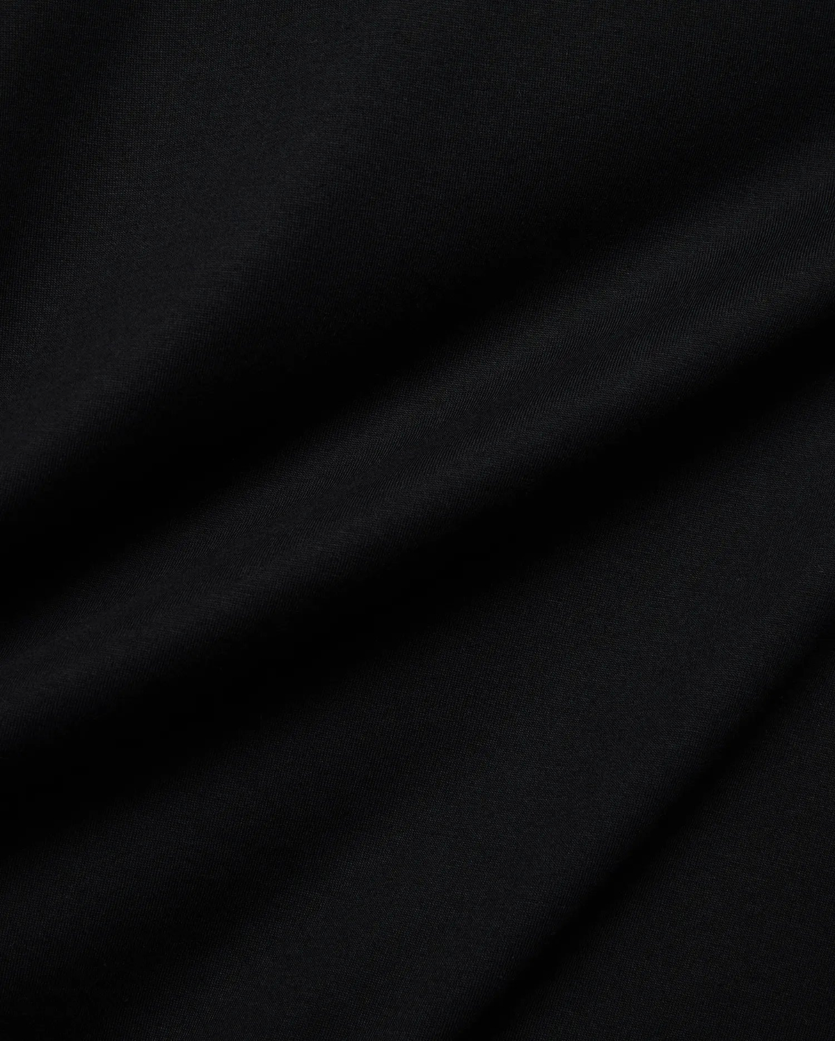 Mens Holden Tee, a premium Psycho Bunny black t-shirt crafted from soft jersey knit fabric, displaying subtle drapes and a smooth texture, reflecting refined quality.