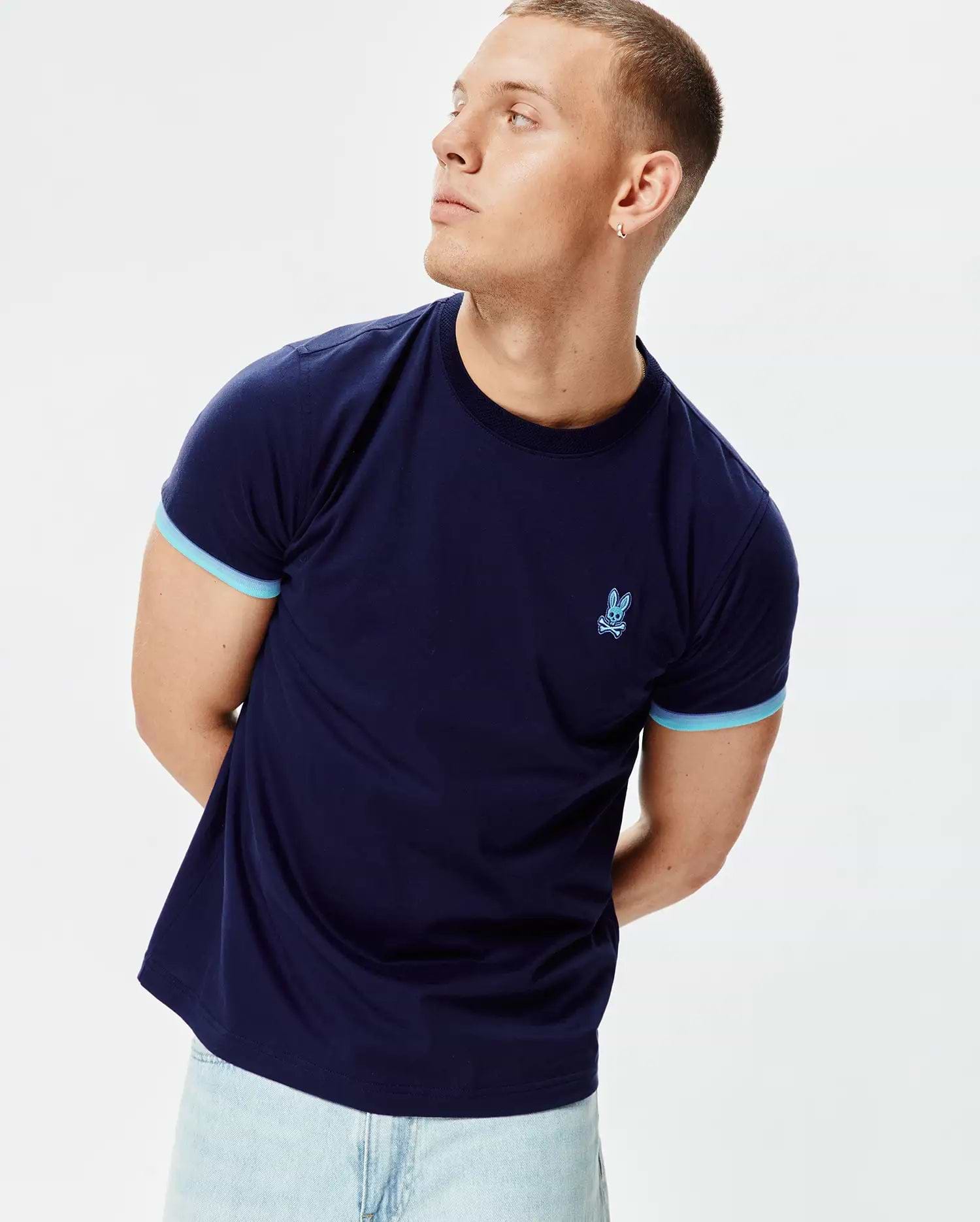 Mens Holden Tee, a navy blue classic fit jersey t-shirt featuring light blue ribbed sleeve cuffs and an embroidered light blue Psycho Bunny skull logo on the left chest. (3)
