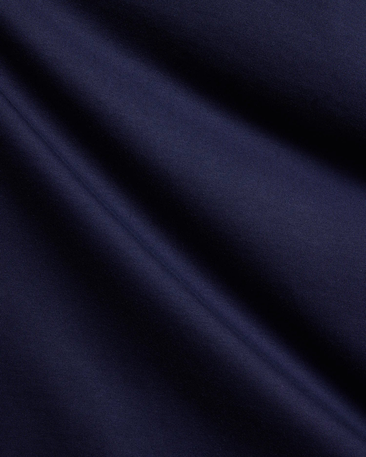 Premium Psycho Bunny Mens Holden Tee fabric swatch, showcasing a rich, deep navy blue color and a smooth, fine jersey knit texture with soft, flowing diagonal folds. (6)