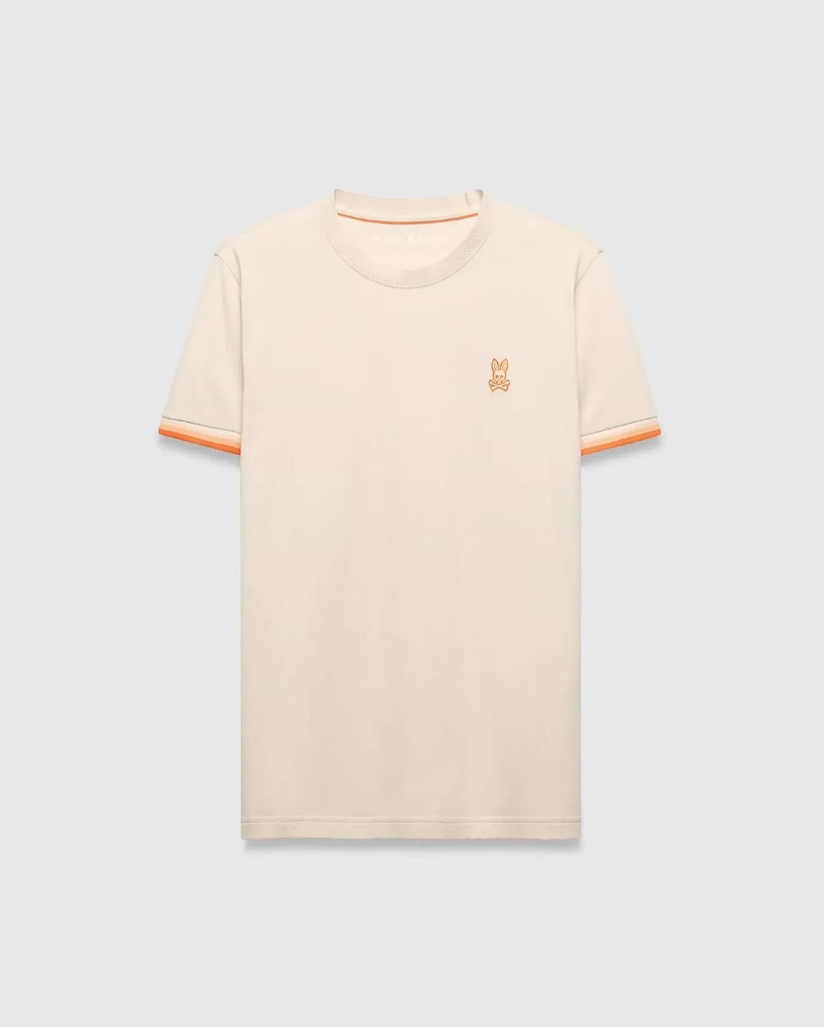 Mens Holden Tee, a classic fit cream jersey knit t-shirt with orange ribbed crew neck, striped sleeve cuffs, and small embroidered orange Psycho Bunny skull logo on left chest. (5)