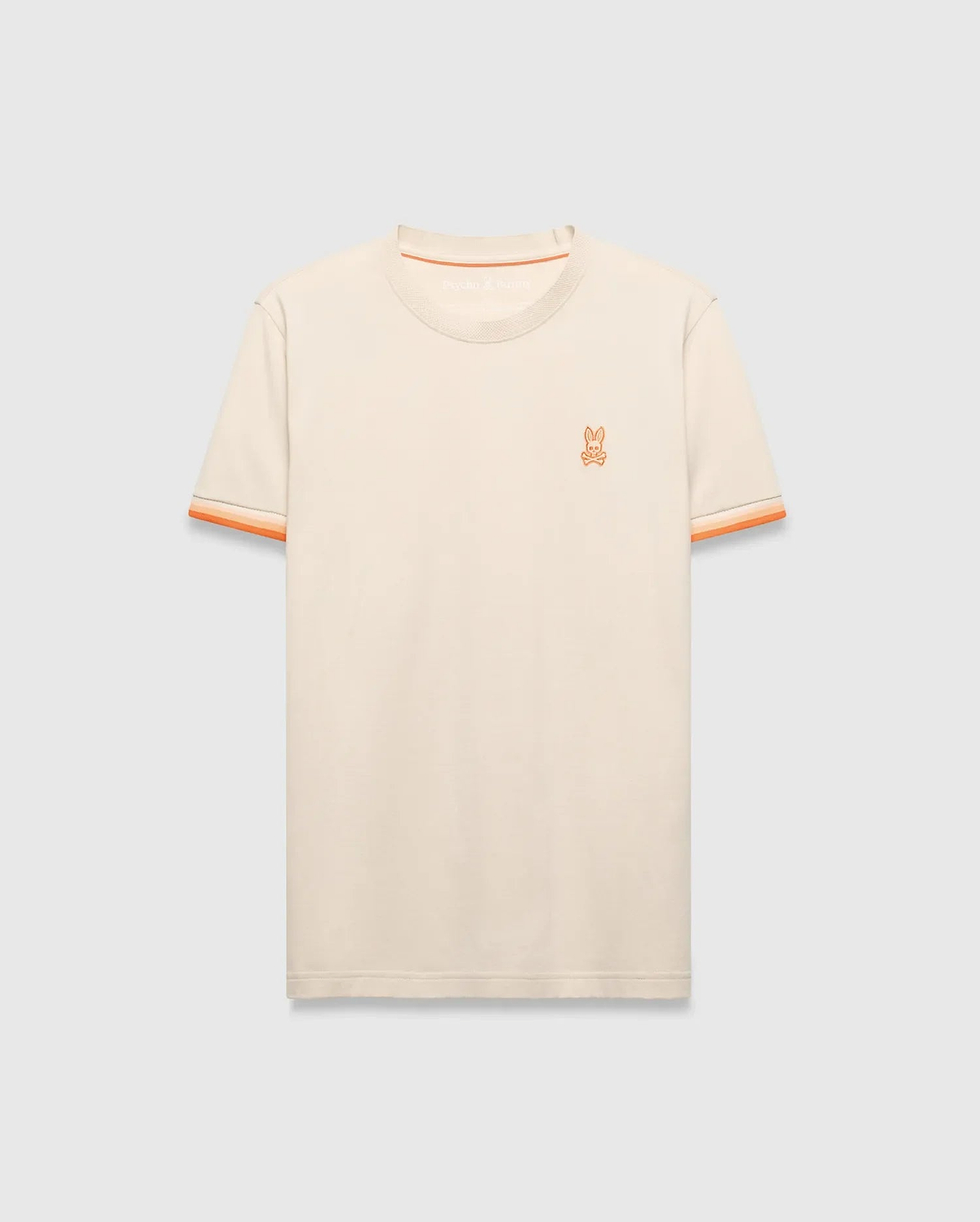 Mens Holden Tee, a classic fit cream jersey knit t-shirt with orange ribbed crew neck, striped sleeve cuffs, and small embroidered orange Psycho Bunny skull logo on left chest. (5)