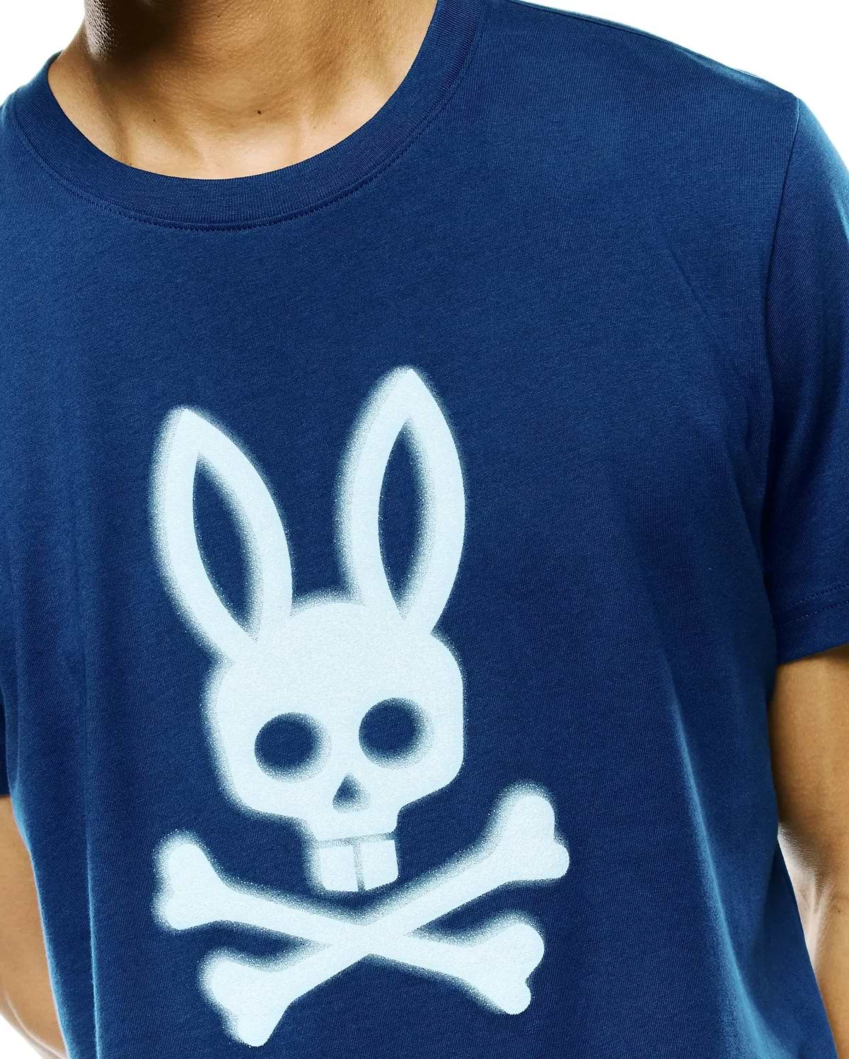 Mens Emmanuel Graphic Tee, a classic fit navy blue jersey t-shirt featuring a large, light blue spray-painted Psycho Bunny skull and crossbones graphic on the center chest.