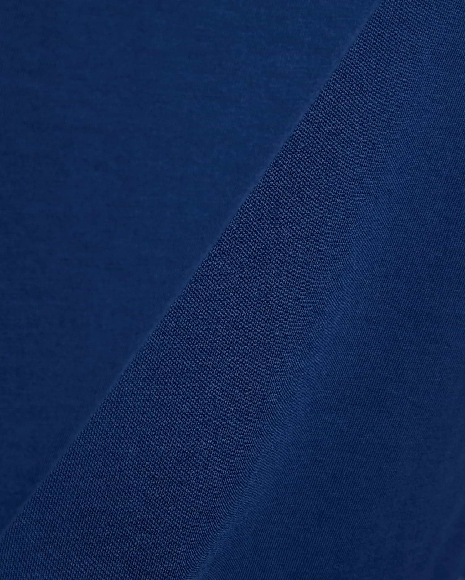 Mens Emmanuel Graphic Tee in rich navy blue, showcasing a soft, smooth jersey fabric on the main body, complemented by a finely textured, diagonal ribbed knit detail.
