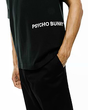 Mens Haiden Relaxed Heavy Weight Tee in black, featuring a large white horizontal PSYCHO BUNNY text logo across the chest, crafted from a smooth, heavyweight jersey fabric.