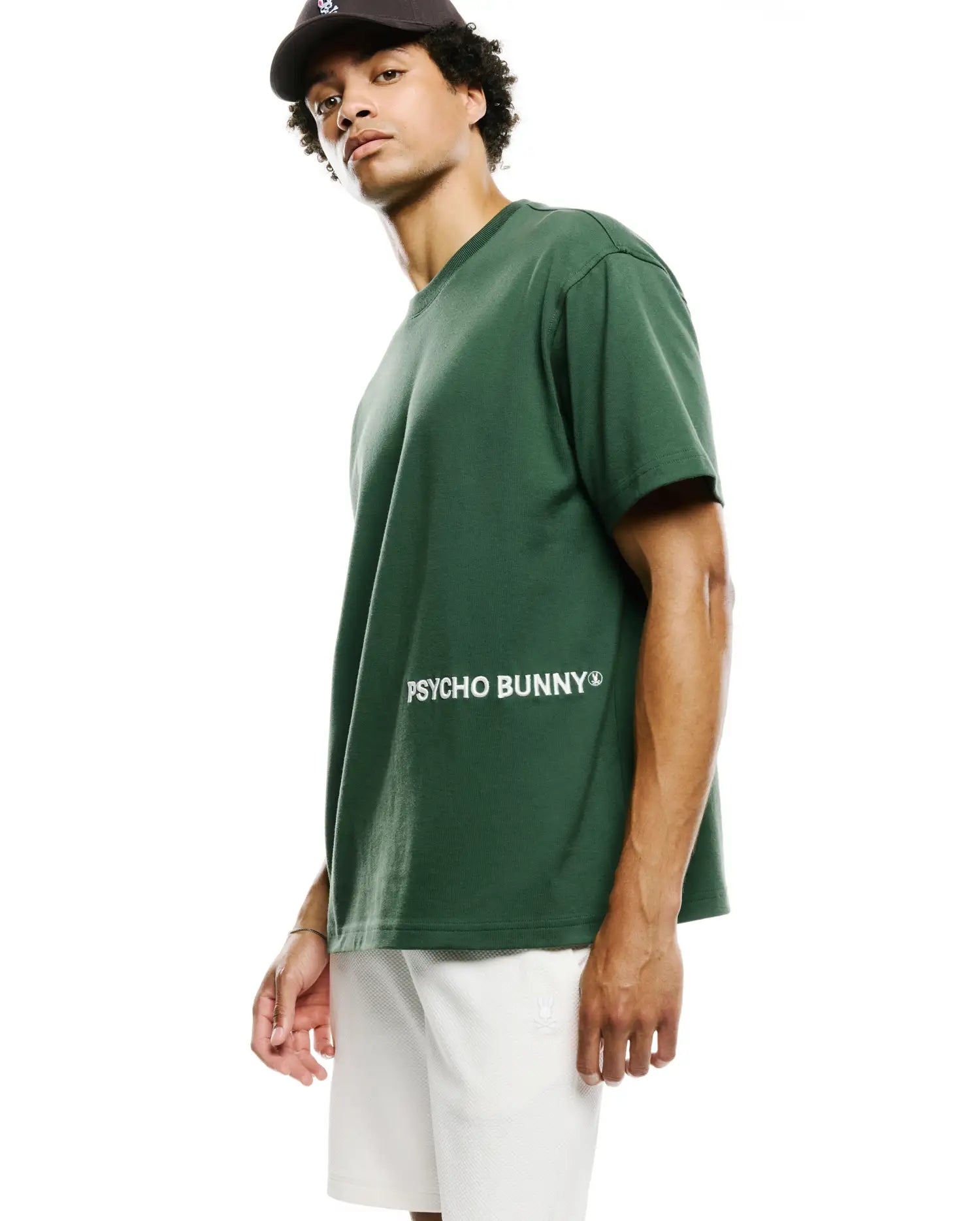 Mens Haiden Relaxed Heavy Weight Tee in dark green, featuring a large white PSYCHO BUNNY® text logo across the chest, made from heavyweight jersey fabric.