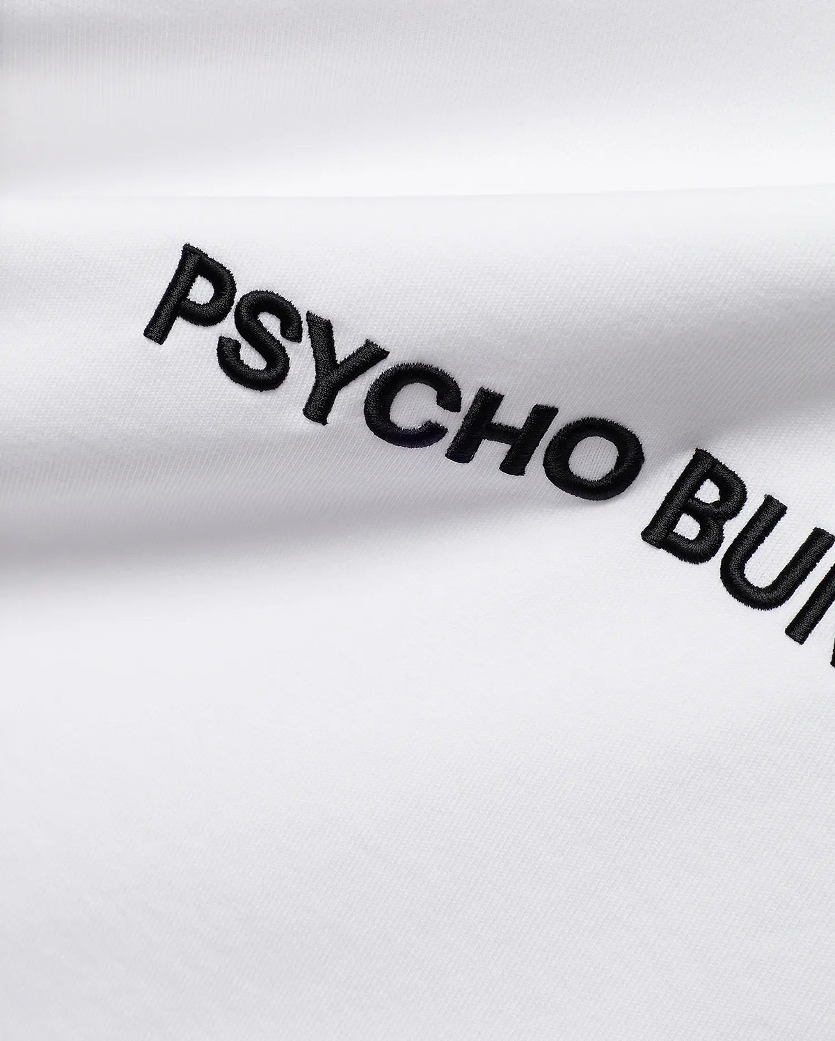 White Mens Haiden Relaxed Heavy Weight Tee, a heavy jersey knit, featuring prominent black embroidered PSYCHO BUNNY text diagonally across the front.