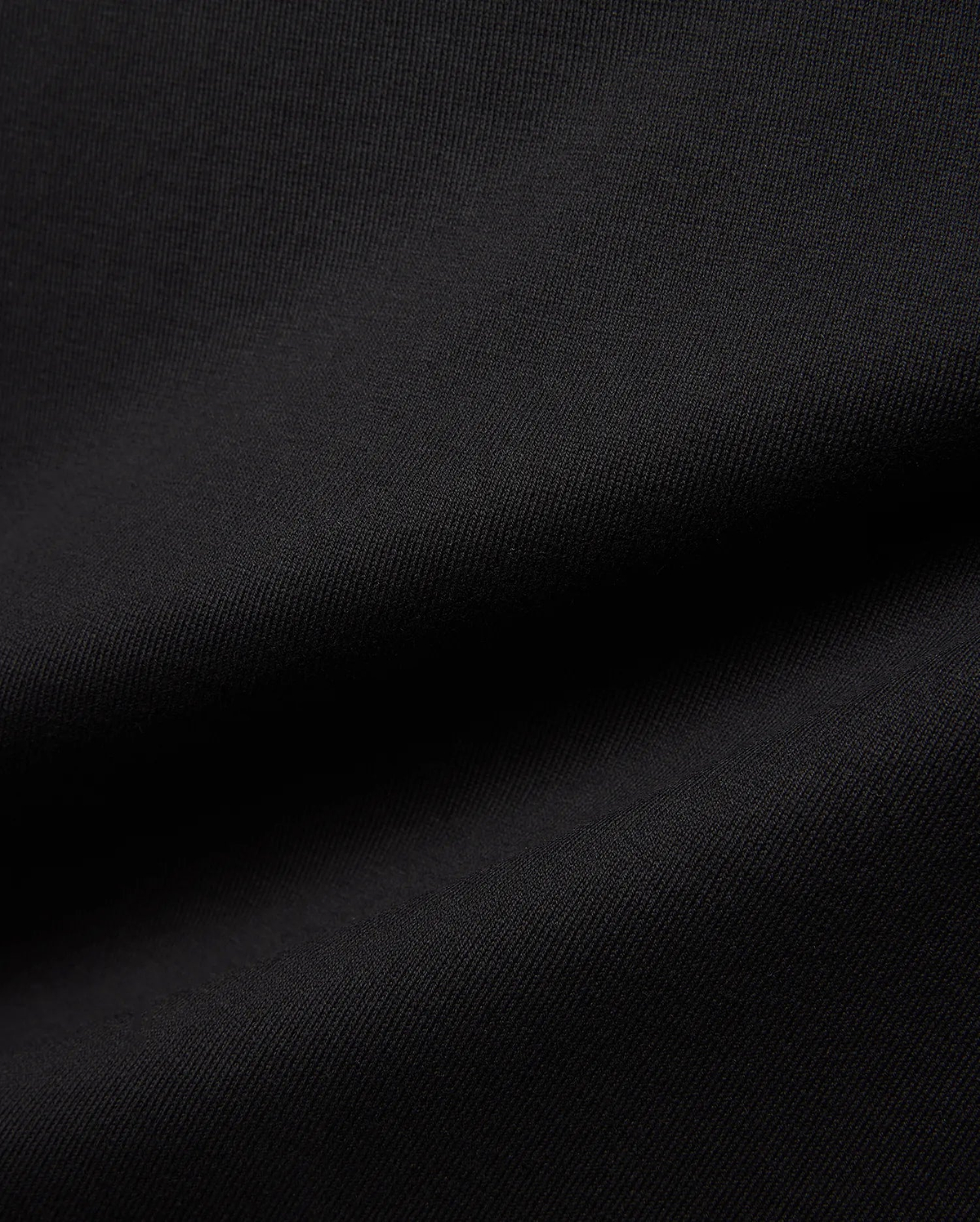 Mens Jaydon Relaxed Fit Tee in deep black, crafted from a premium, soft-touch jersey knit fabric with a subtle, refined texture, embodying Psycho Bunny's signature comfortable streetwear aesthetic.