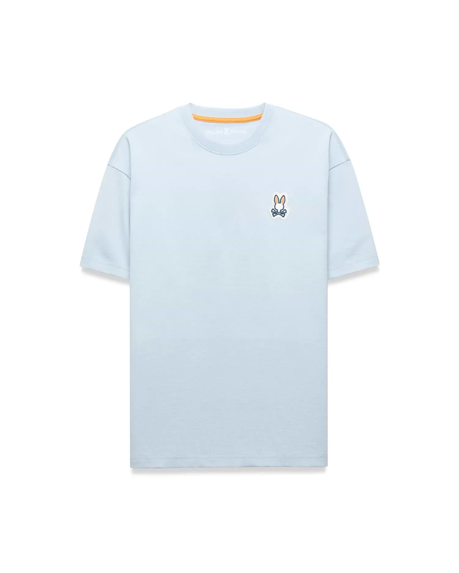 Light blue Mens Jaydon Relaxed Fit Tee in soft jersey, featuring a small embroidered Psycho Bunny skull logo on the left chest and orange neck tape.