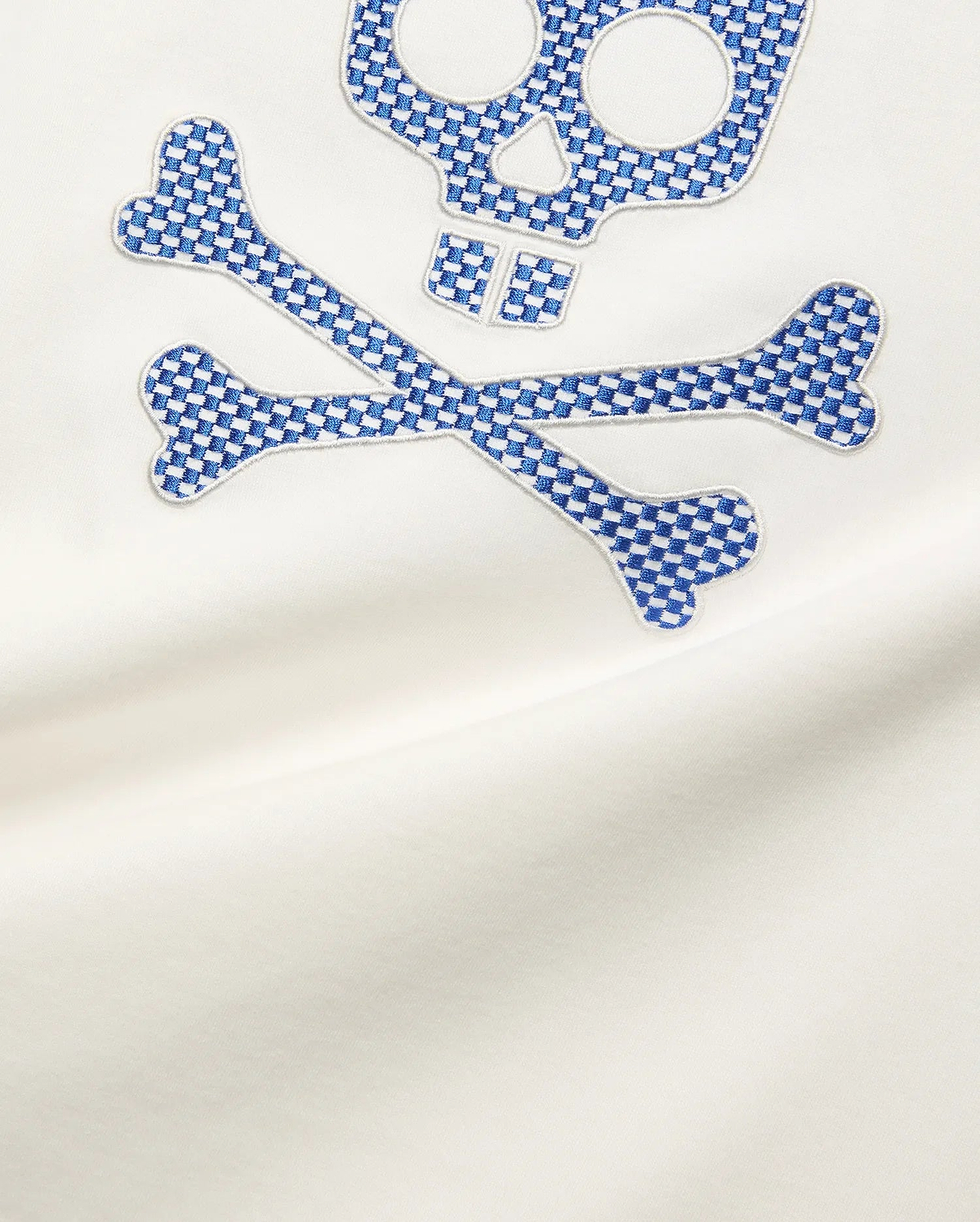 Mens Stan Graphic Tee in white smooth jersey, featuring a large embroidered Psycho Bunny skull and crossbones logo with a blue and white checkerboard pattern.