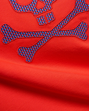 Mens Stan Graphic Tee in vibrant red jersey knit, featuring a large embroidered bunny skull and crossbones logo with a blue and red checkered pattern.