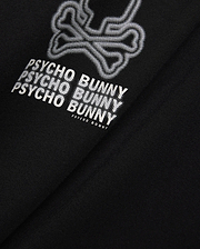 Mens Alex Relaxed Back Graphic Tee in black jersey knit, featuring a large white dotted outline bunny skull and repeated Psycho Bunny text graphic on the back. (6)